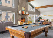 Thumbnail 5 of 40 - a pool table in a living room with a fireplace