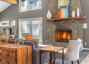 Thumbnail 6 of 40 - a living room with a fireplace and a large window
