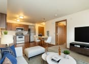 Thumbnail 3 of 14 - a living room with a couch and a table with a television