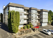 Thumbnail 17 of 20 - an aerial view of an apartment building in a parking lot with cars