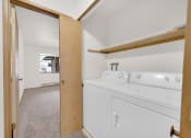 Thumbnail 15 of 20 - a washer and dryer in a room with a door to a laundry room