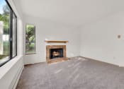 Thumbnail 3 of 20 - a living room with a fireplace and a window