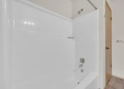 Thumbnail 9 of 20 - a white bathroom with a shower and a tub
