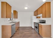 Thumbnail 5 of 20 - an empty kitchen with wooden cabinets and stainless steel appliances