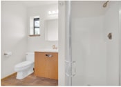 Thumbnail 12 of 20 - a small bathroom with a toilet and a shower