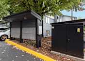 Thumbnail 21 of 21 - A black utility box is on the side of a road.