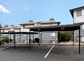 Thumbnail 20 of 21 - A parking lot with a car parked in front of a building with the numbers 48 and 47 on it.