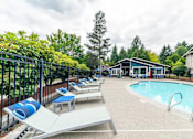 Thumbnail 14 of 19 - A pool area with sun loungers and a slide.