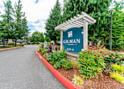 Thumbnail 9 of 19 - A sign that says Gilman 360 stands in front of a garden.