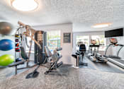 Thumbnail 15 of 19 - A well equipped gym with a variety of exercise equipment.