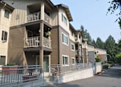 Thumbnail 5 of 27 - Apartment building with balconies and a metal railing.
