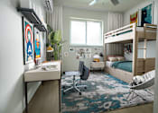 Thumbnail 3 of 6 - A room with a bunk bed, a desk, and a chair.