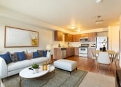 Thumbnail 1 of 14 - a living room with a couch and a table