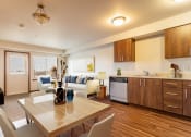 Thumbnail 2 of 14 - a living room with a kitchen and a dining table