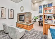 Thumbnail 9 of 9 - A living room with a grey carpet and a stone fireplace.