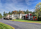 Thumbnail 2 of 18 - A street view of a residential area with houses and trees.