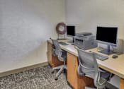 Thumbnail 4 of 9 - A computer desk with a monitor, keyboard, and printer.