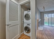 Thumbnail 5 of 9 - A white door opens to a laundry room with a washer and dryer.
