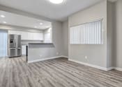 Thumbnail 25 of 31 - A kitchen with a refrigerator and a countertop is visible.