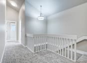 Thumbnail 20 of 31 - A white staircase with a carpeted floor.