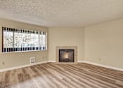 Thumbnail 13 of 16 - A room with a fireplace and a window with blinds.