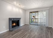 Thumbnail 21 of 25 - A room with a fireplace and sliding glass doors.