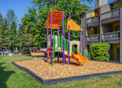 Thumbnail 18 of 25 - A playground with a slide and a swing set.