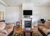 Thumbnail 2 of 19 - a living room with couches and a fireplace and a television