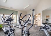 Thumbnail 5 of 19 - a gym with cardio equipment and weights at the enclave apartments