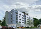 Thumbnail 1 of 5 - a rendering of an apartment building on a city street