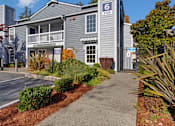 Thumbnail 15 of 16 - A building with the number 6 on it is surrounded by plants and trees.