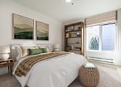 Thumbnail 7 of 27 - A bedroom with a large bed and two landscape paintings on the wall.