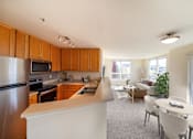 Thumbnail 21 of 21 - A kitchen with wooden cabinets and a white counter.