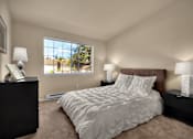 Thumbnail 2 of 16 - A bedroom with a large bed and two lamps.