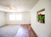 Thumbnail 11 of 20 - A room with a ceiling fan and a carpeted floor.
