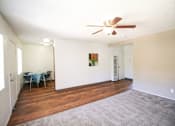 Thumbnail 12 of 20 - A room with a ceiling fan and a dining table with chairs.