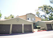 Thumbnail 14 of 20 - A two-story house with a garage and a driveway.