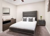 Thumbnail 13 of 20 - Bedroom with Grey Bed at Arbor Park Apartments, Jackson, MS, 39209