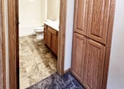 Thumbnail 7 of 30 - A bathroom with a toilet, sink and wooden door.