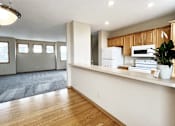Thumbnail 5 of 30 - A kitchen with wooden cabinets and a white fridge.