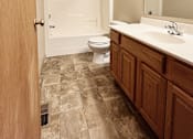 Thumbnail 15 of 30 - A bathroom with a toilet, sink and mirror.