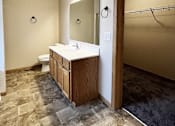 Thumbnail 22 of 30 - A bathroom with a toilet, sink, and mirror.