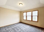 Thumbnail 18 of 30 - A room with a carpeted floor and a window.