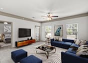Thumbnail 24 of 59 - a living room with a couch coffee table and a tv on the wall at Stonepost Crossing Apartments, Overland Park, Kansas