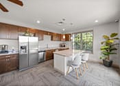 Thumbnail 25 of 50 - A modern kitchen with a white island and stainless steel appliances. at The Dorset, Kansas City, MO
