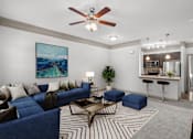 Thumbnail 25 of 59 - a living room with a blue couch and a coffee table at Stonepost Crossing Apartments, Kansas, 66213