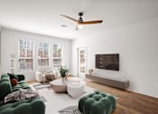 Thumbnail 3 of 23 - A living room with hardwood floors, a ceiling fan, and windows at Mirabelle Luxury Apartments, Kansas City, Missouri