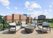 Thumbnail 27 of 50 - A patio with four chairs and a table with a view of a city skyline.at The Dorset, Kansas City, 64112