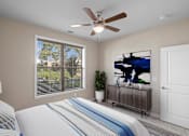 Thumbnail 8 of 50 - a bedroom with a large window and a ceiling fan at The Dorset, Kansas City, 64112