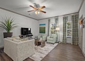 Thumbnail 3 of 59 - a living room with a ceiling fan and couches at Stonepost Crossing Apartments, Overland Park, KS